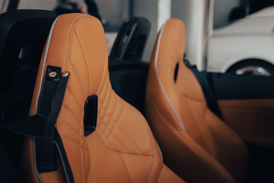 Close-up view of a high-end car interior featuring elegant leather seats, showcasing luxury and comfort.